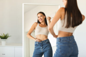 Woman looking at herself in the mirror
