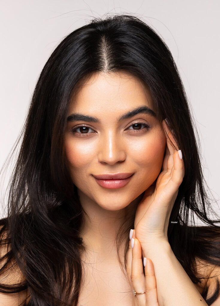 Woman with dark hair smirking